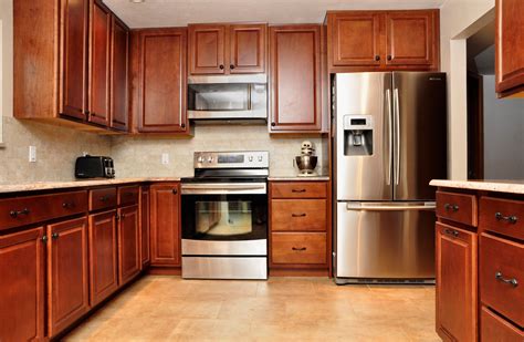 cherry cabinets with black stainless steel appliances|cherry finished kitchen cabinets.